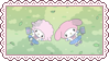 A stamp of the Sanrio characters My Sweet Piano and My Melody lying in the grass with school uniforms on